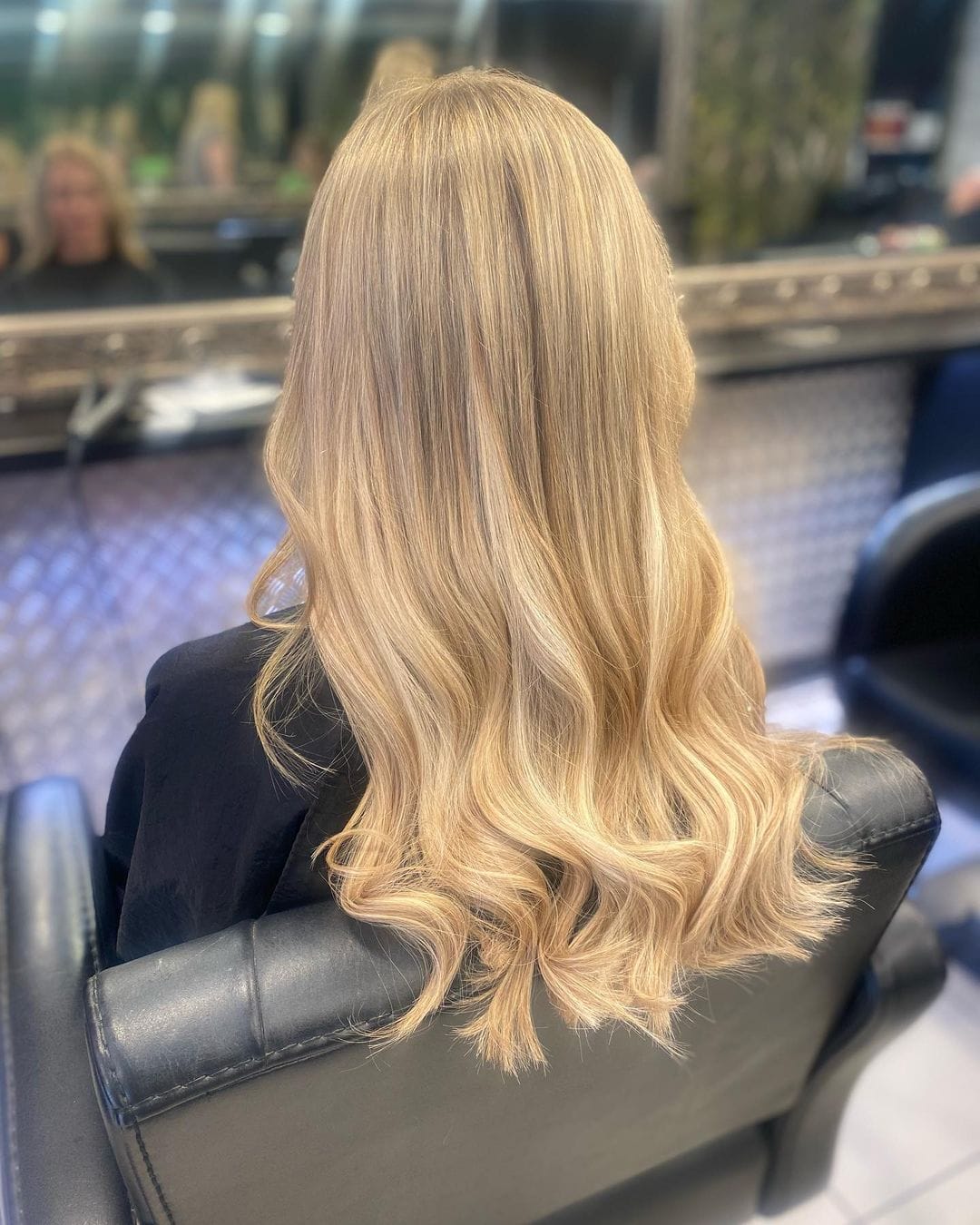 Back of womans blonde beach waves hair